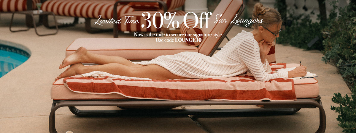 A woman in a white ribbed robe lies on a striped orange and white sun lounger poolside, with promotional text overlay reading 'Limited Time 30% Off Sun Loungers'.