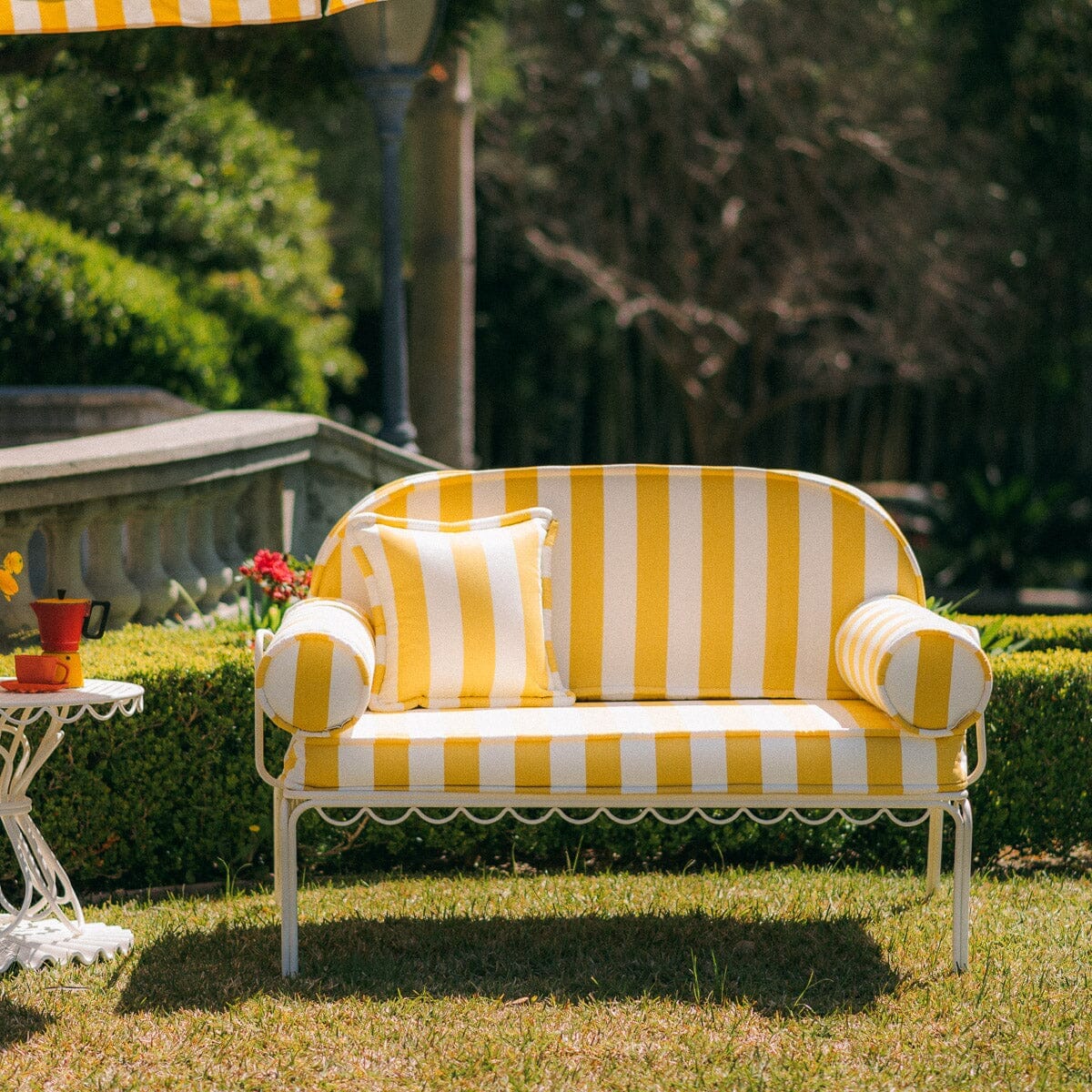 The Al Fresco Love Seat in Crew Mimosa Yellow Stripe | Antique White Frame Al Fresco Love Seat Kit Business & Pleasure Co.