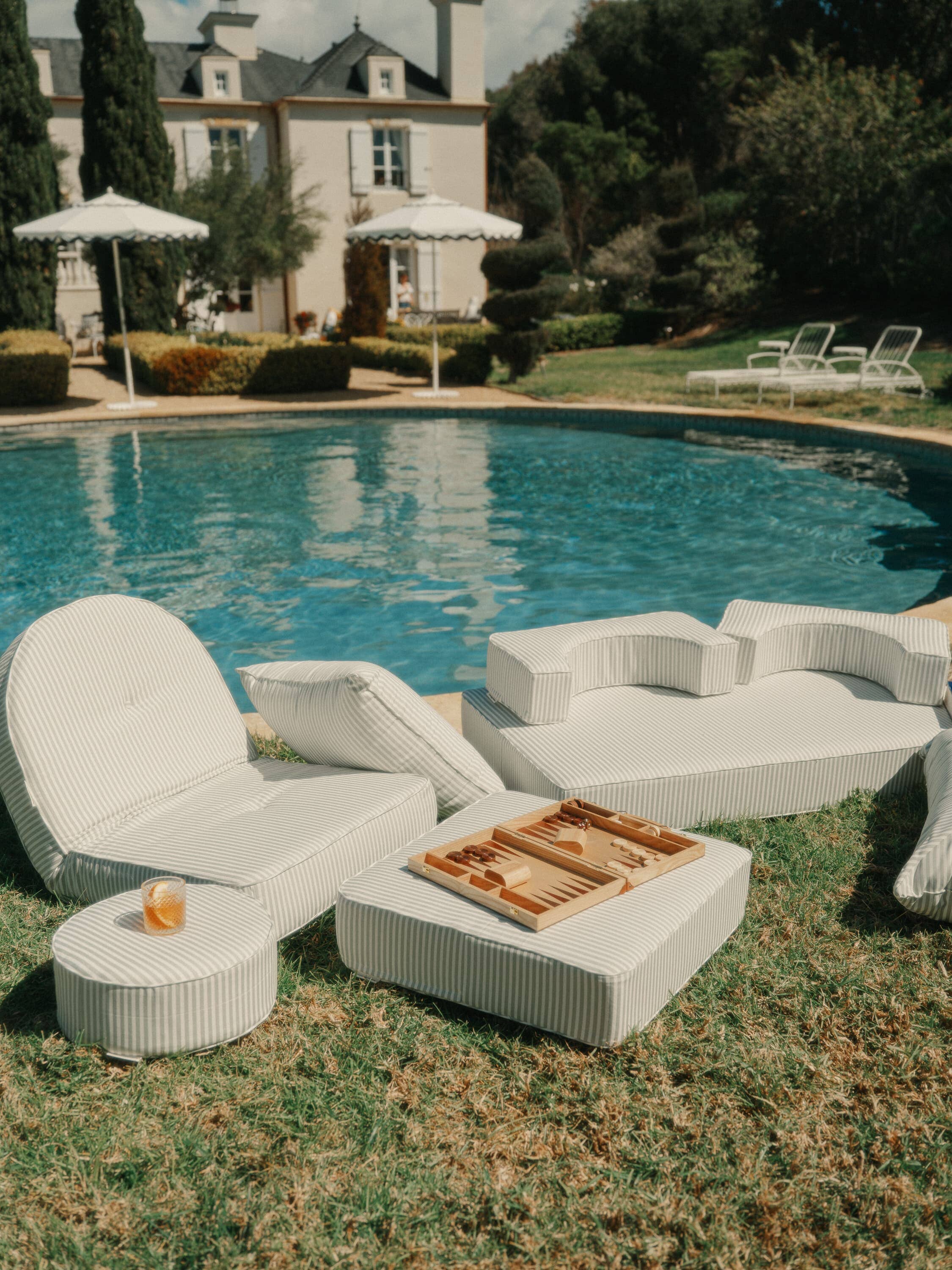 Sage outdoor pillows next to a pool