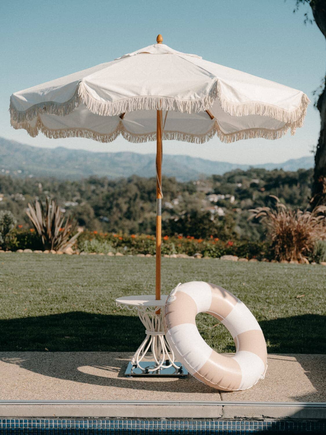 Umbrella and pool float next to a pool