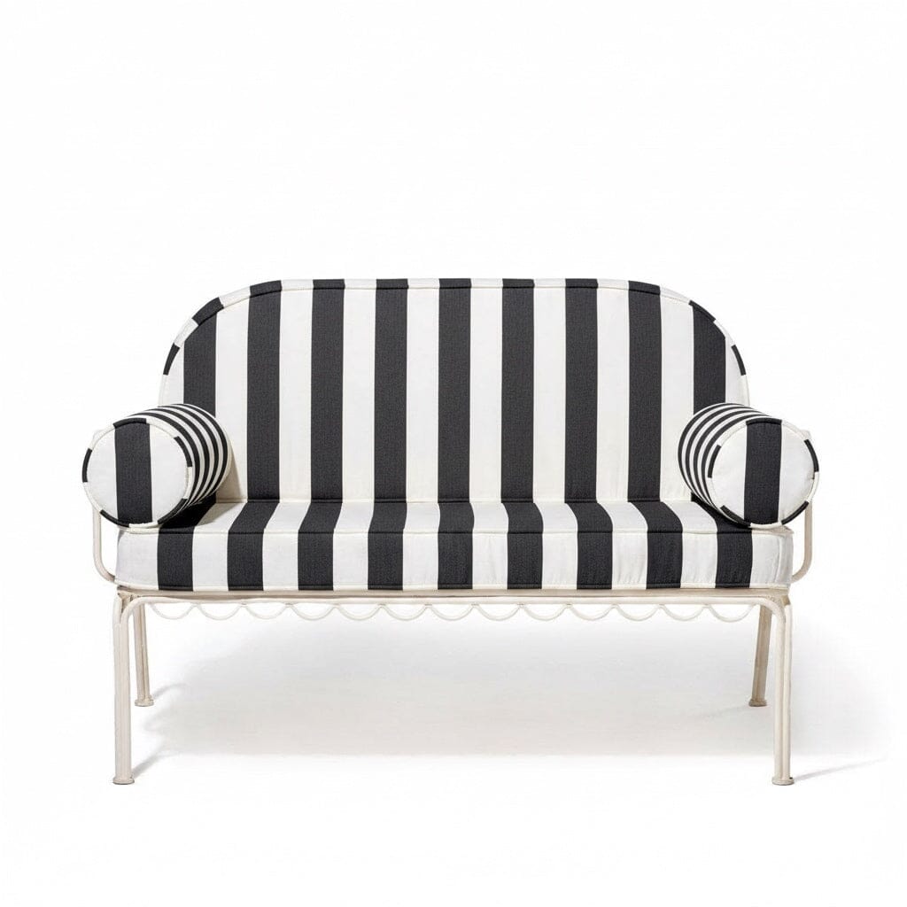 Black and white striped sofa with decorative cushions on a white background