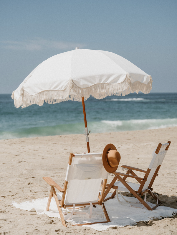 White beach chairs and umbrella