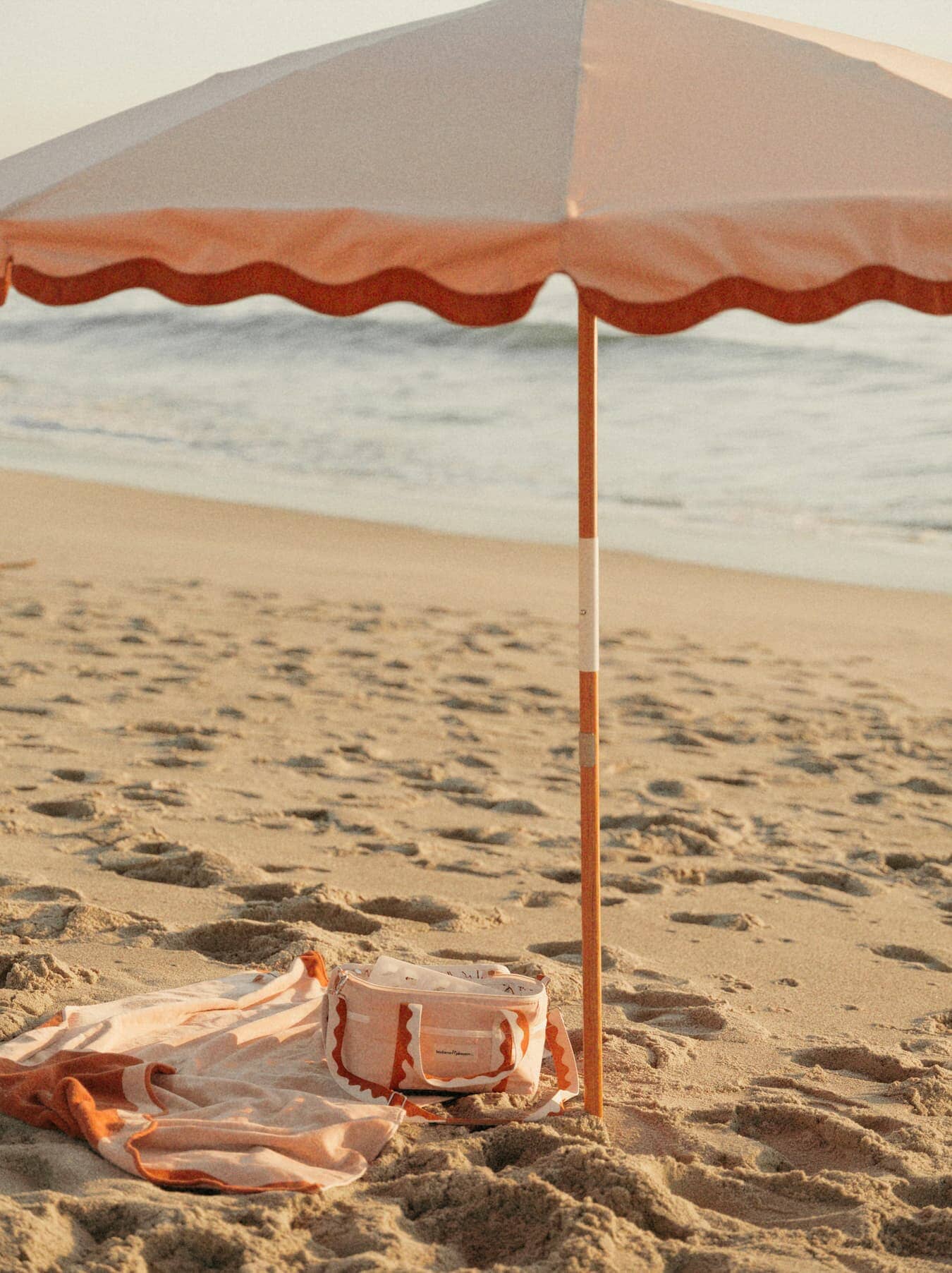 Riviera pink beach set up with amalfi umbrella, chair and accesories. 