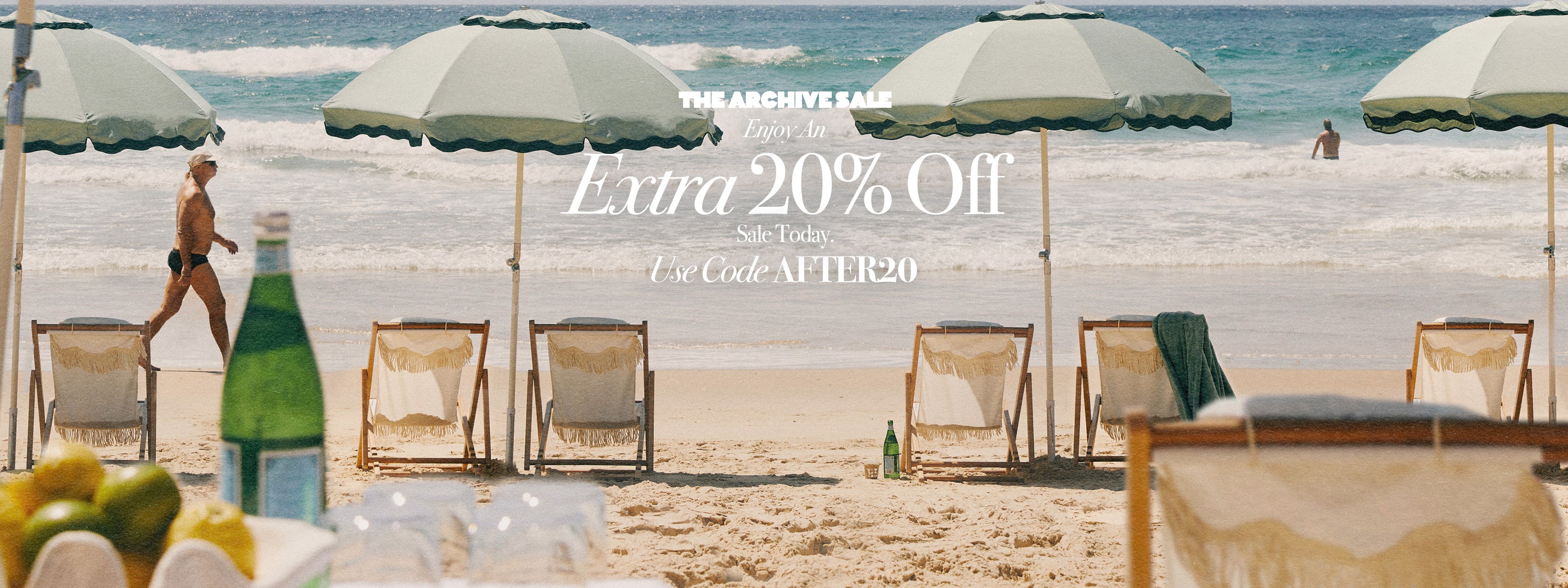 Beach scene with umbrellas and lounge chairs, promotional text overlay for an extra 20% off sale.