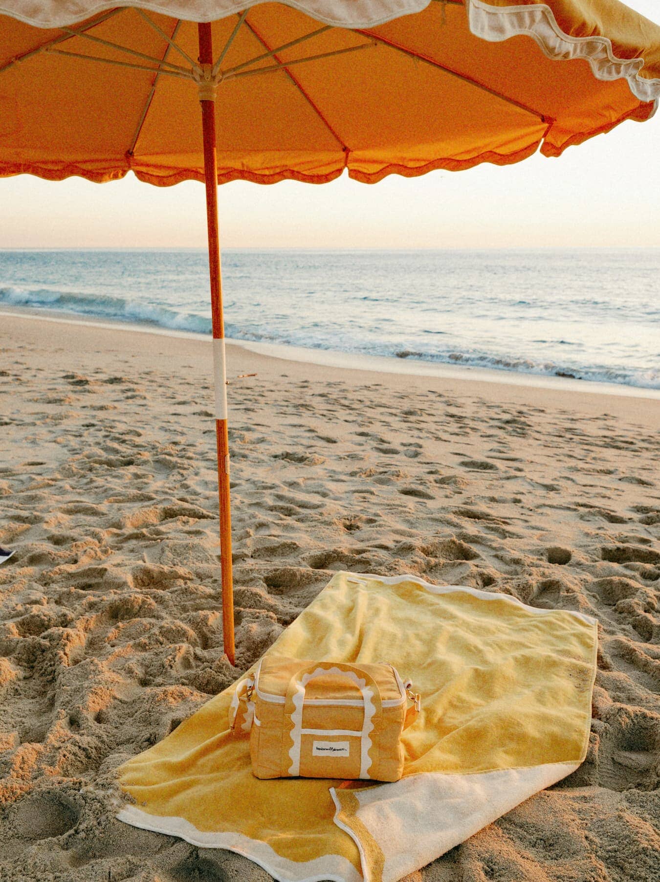 Beach set up with riviera mimosa towel, cooler and umbrella