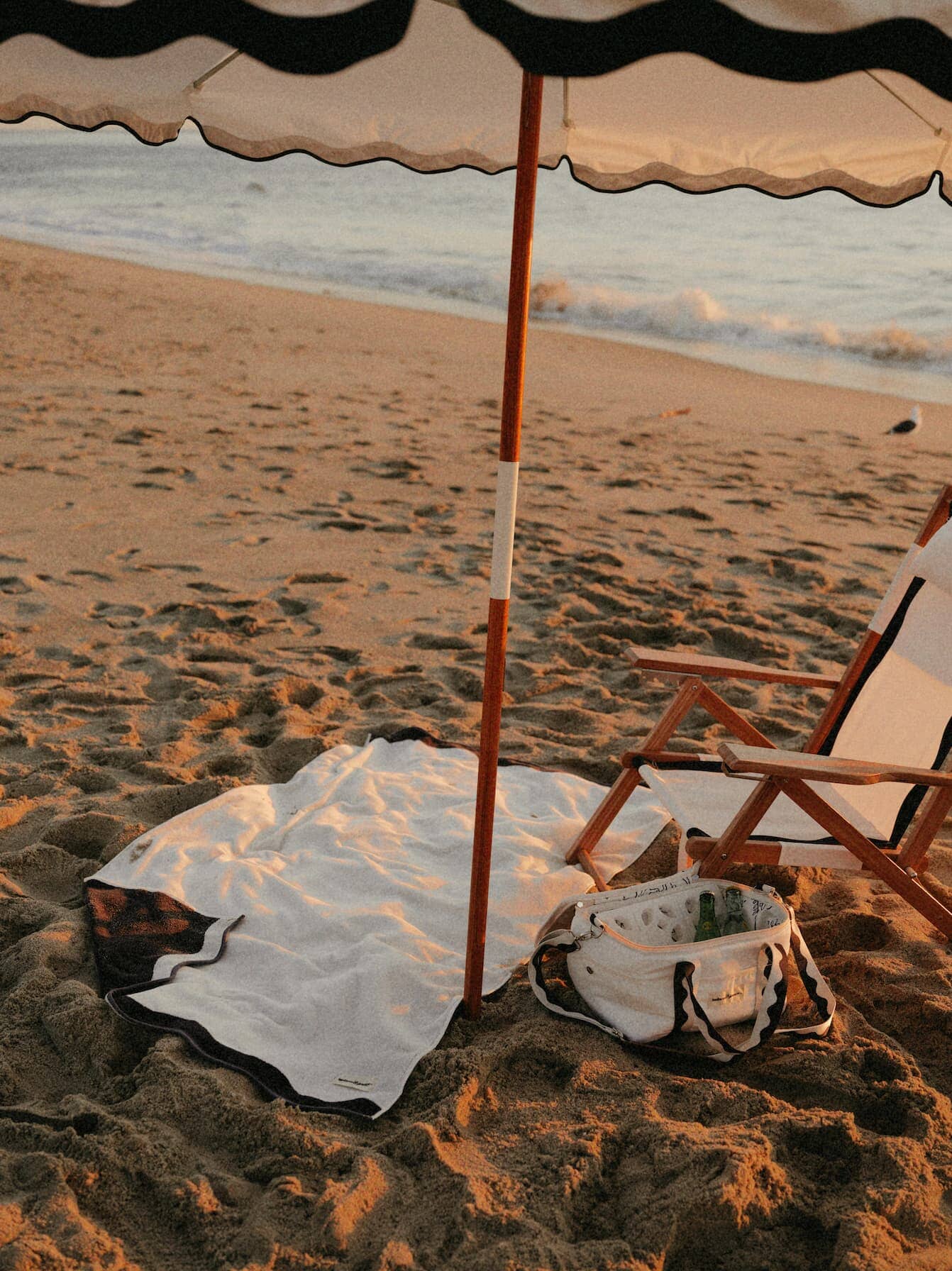 Beach set up with riviera white umbrella, chair, towel and cooler