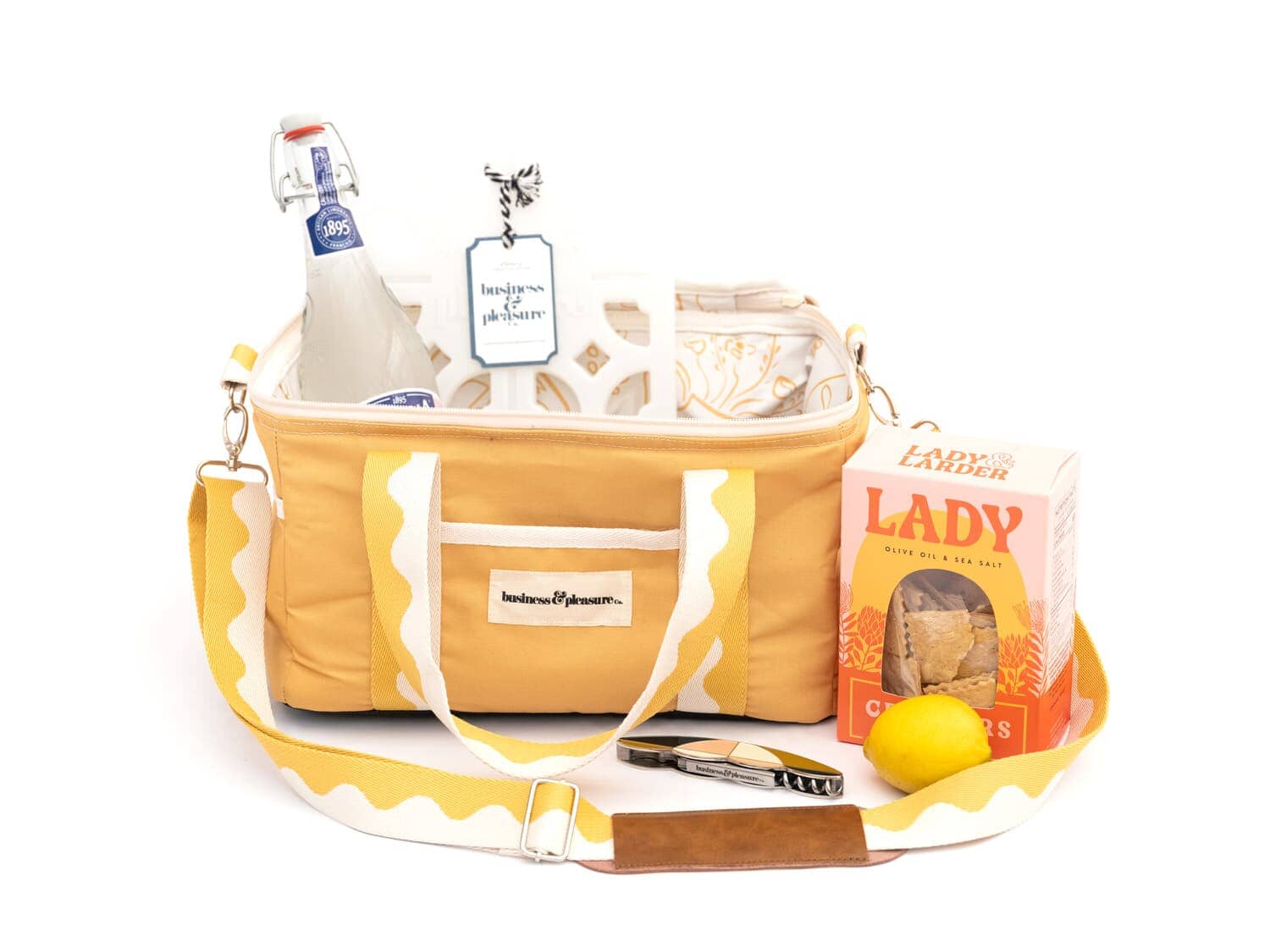 Studio image of riviera mimosa cooler bag with drinks and snacks
