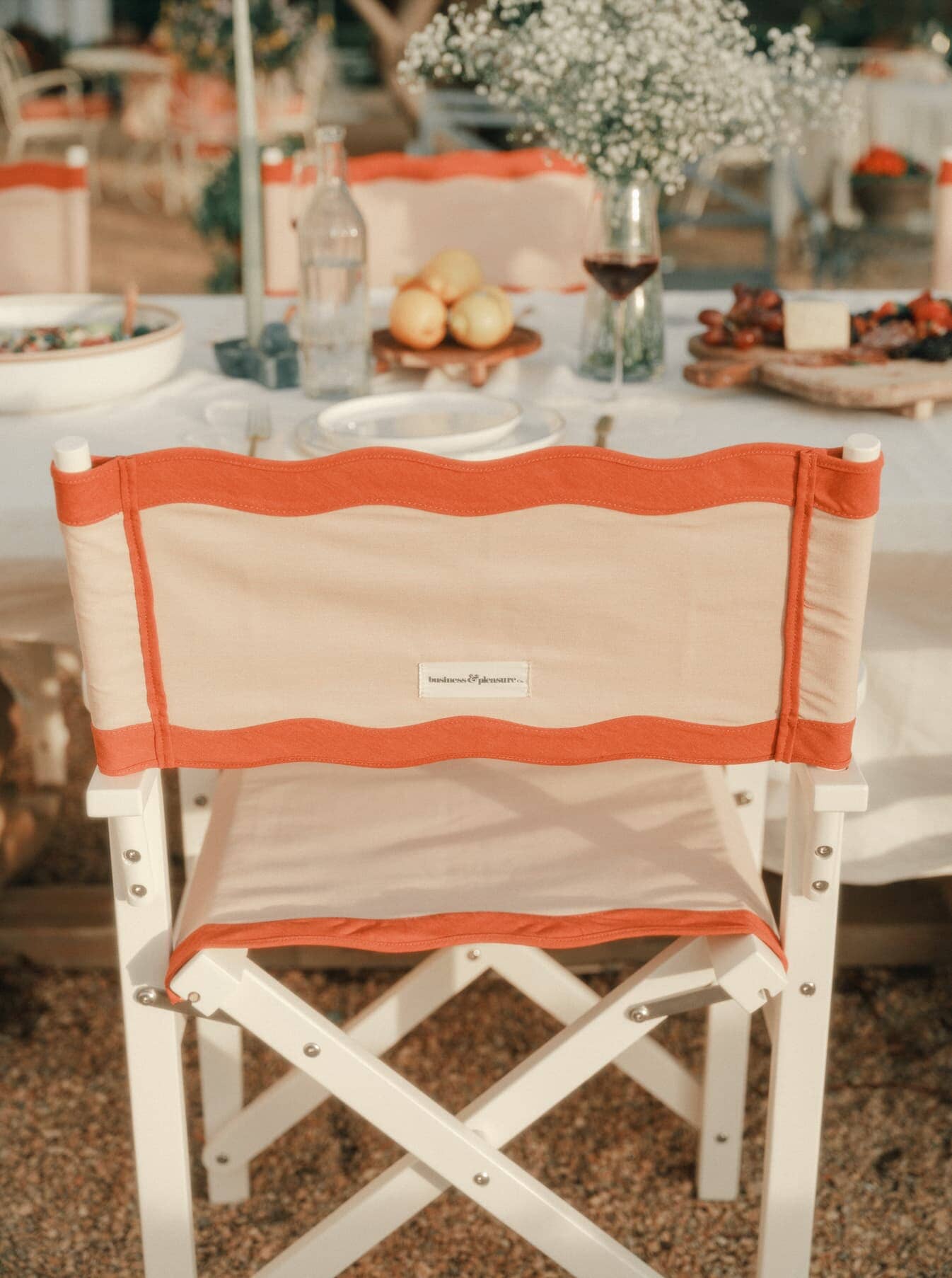 Riviera pink directors chair at an outdoor table