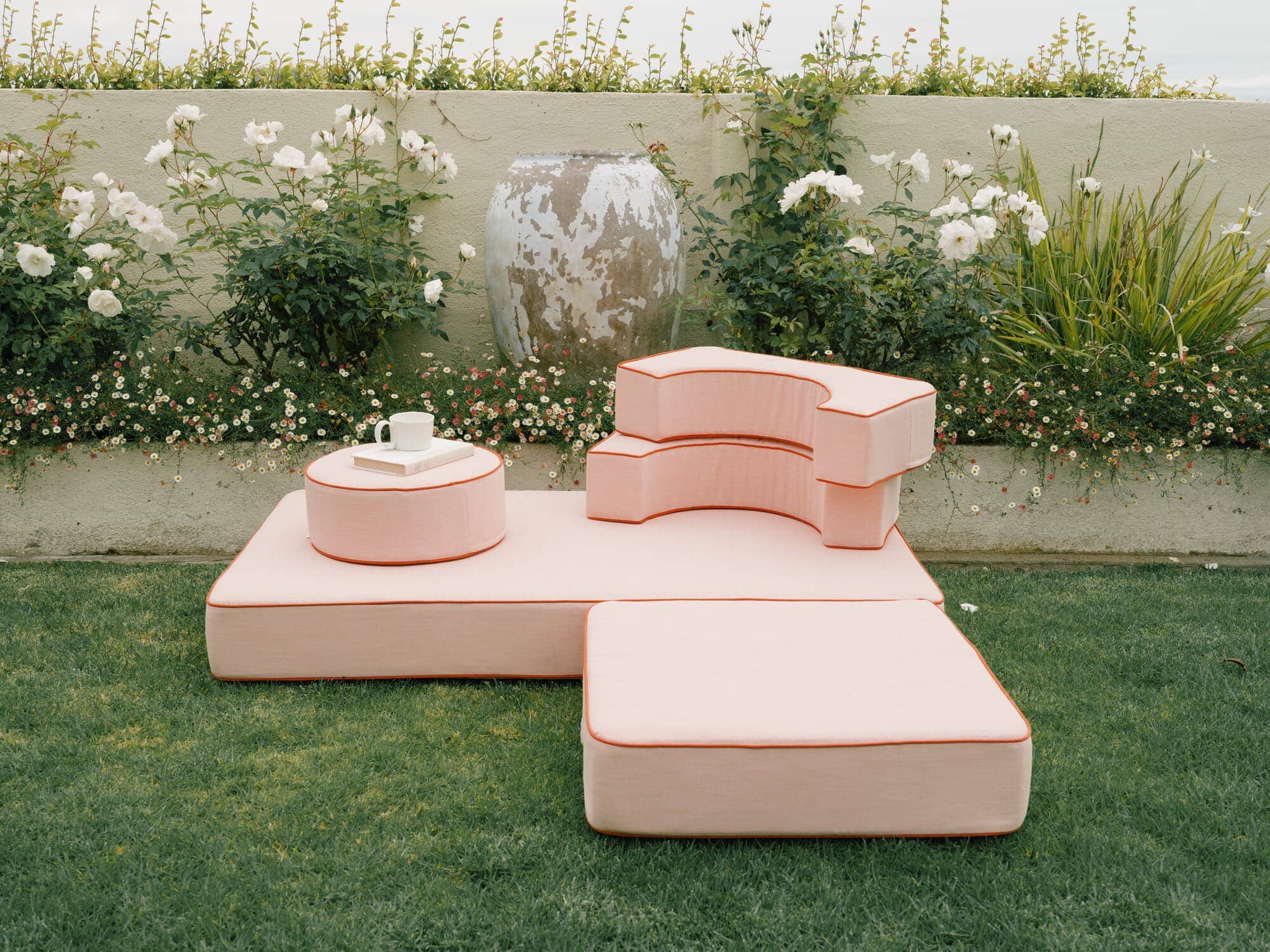 Riviera pink modular pillow stack in a garden setting