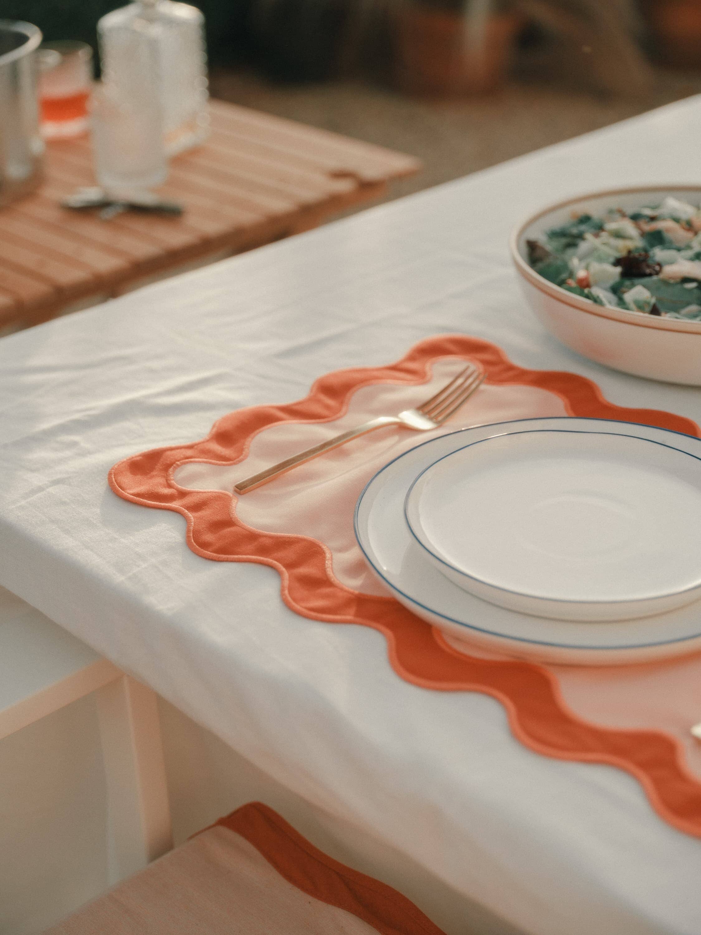 Riviera pink placemat on an outdoor dining table