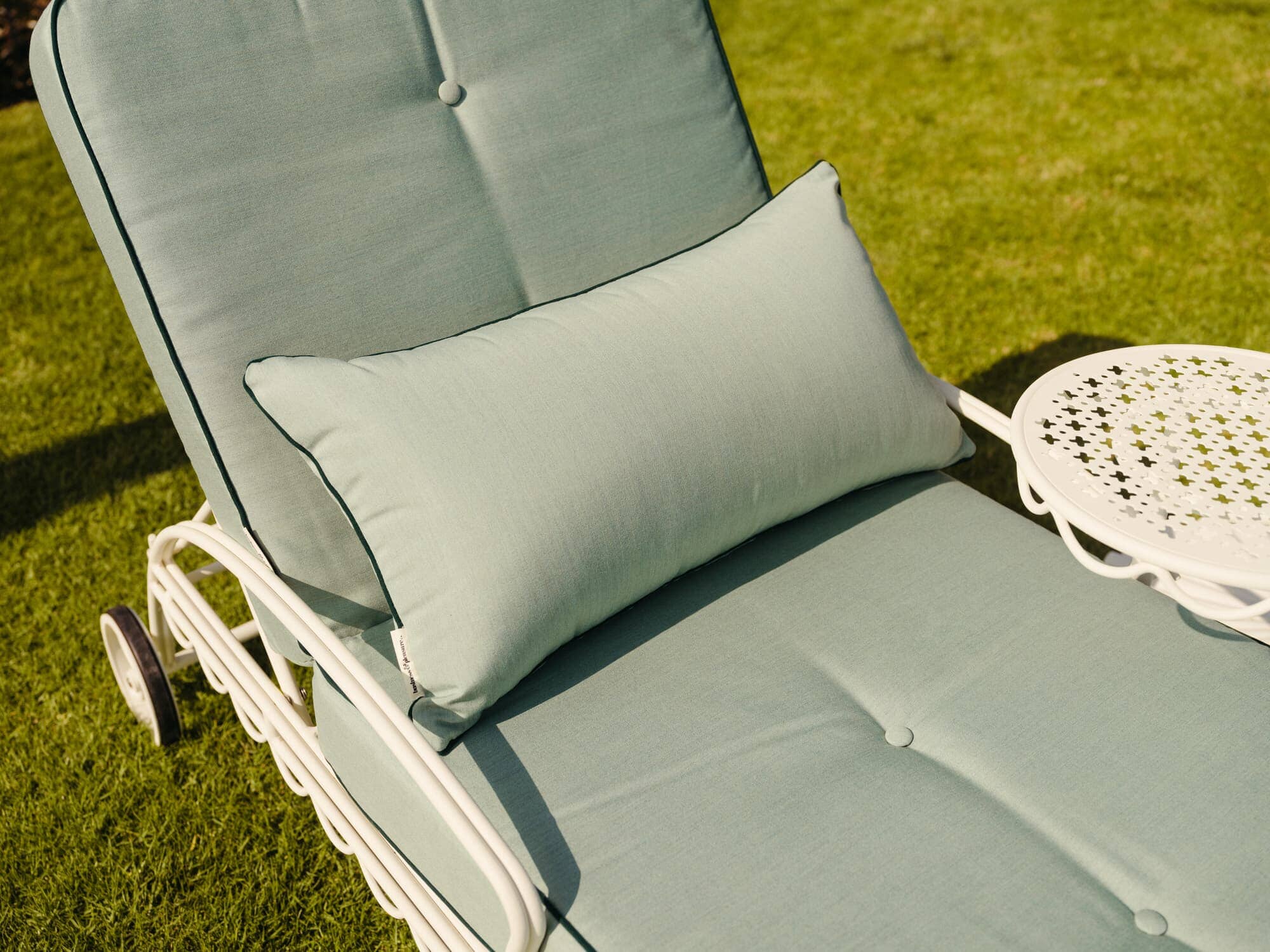 Riviera throw pillow on a sun lounger in the sun