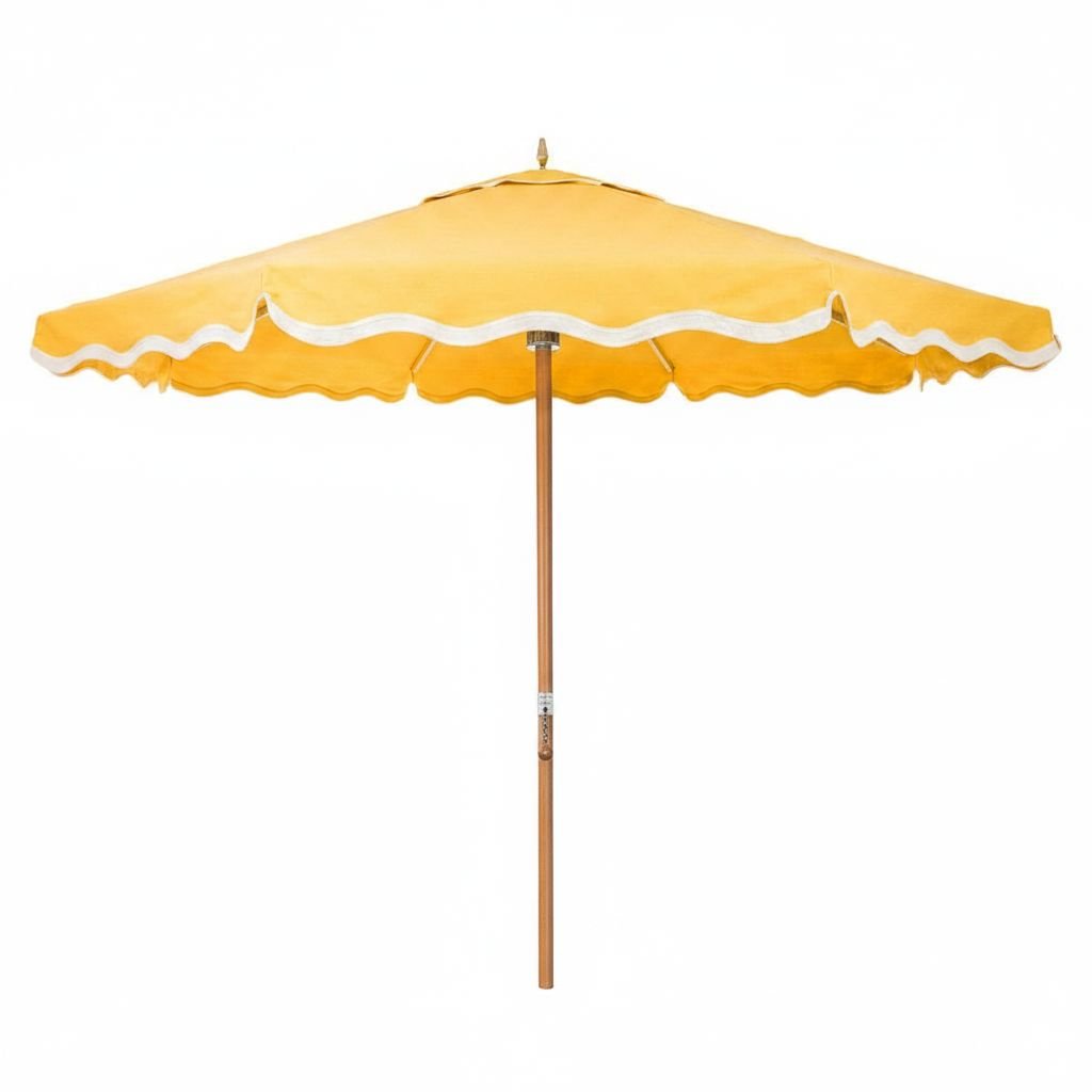 Yellow patio umbrella with white trim on a white background