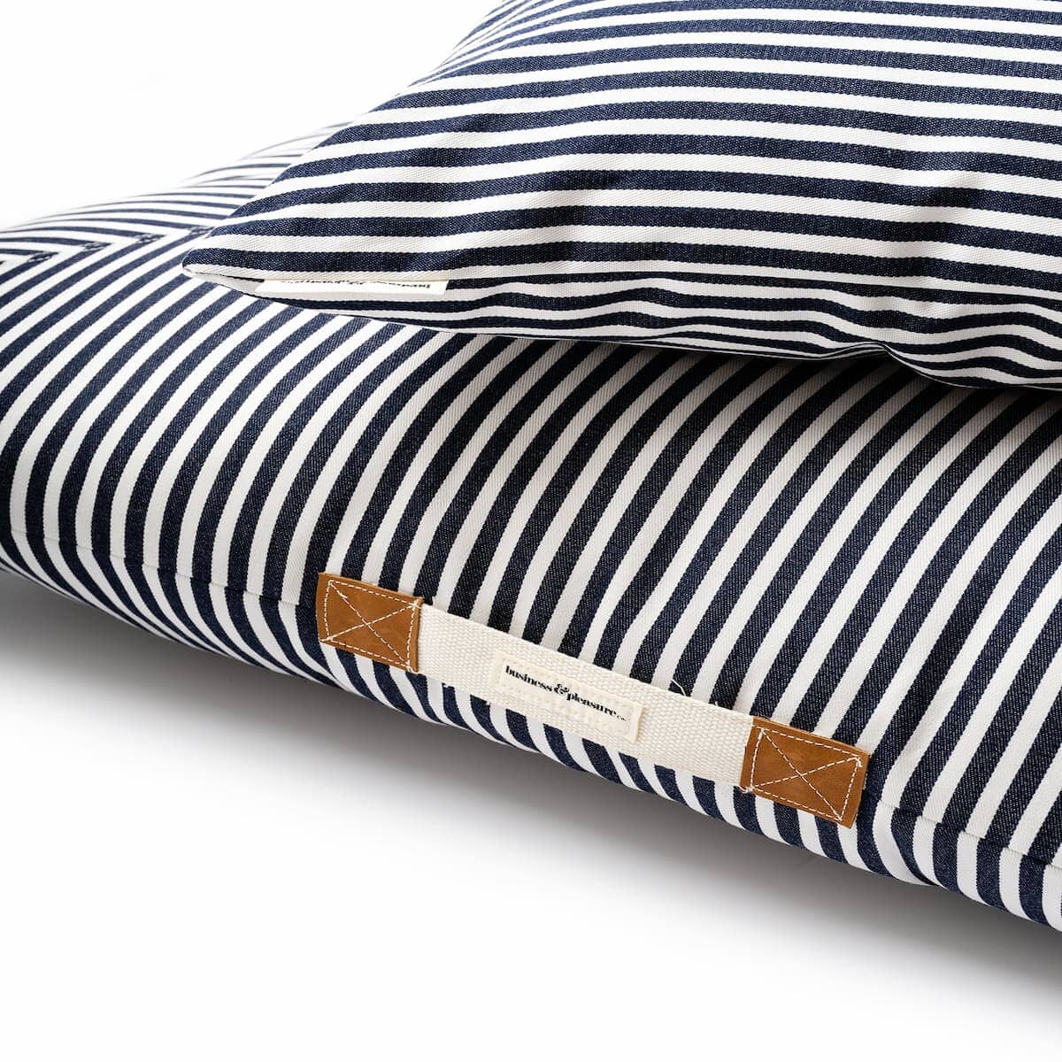 zoomed in studio image of navy stripe euro pillow and floor pillow handle