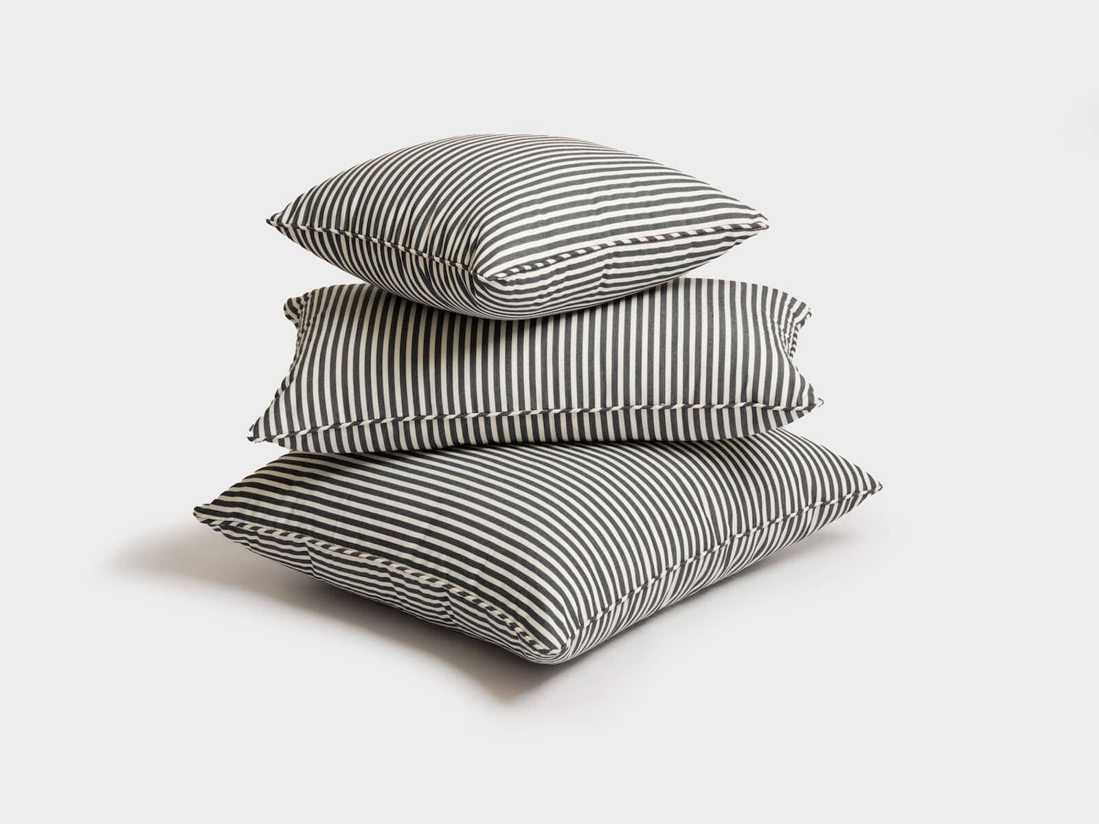 studio images of 3 throw pillows stacked up